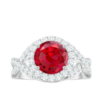 Round created ruby crossover engagement ring with moissanite from Rosec Jewels, featuring a stunning ruby centerpiece and sparkling accents.