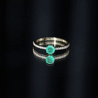 Natural emerald promise ring with diamond side stones from Rosec Jewels featuring a lush green emerald centerpiece and sparkling accents.