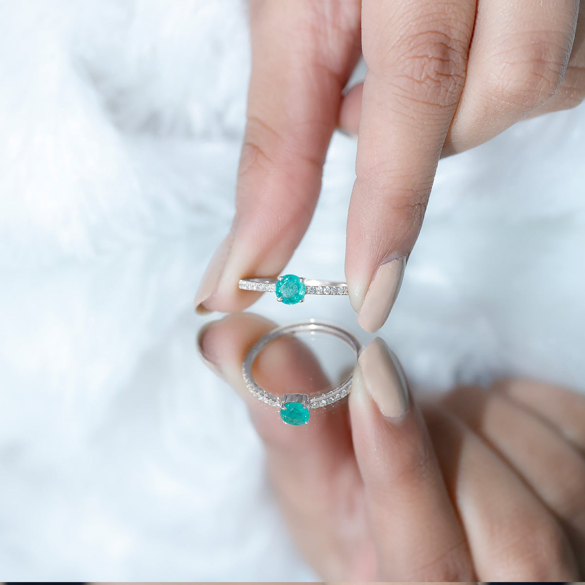 Natural emerald promise ring with diamond side stones, featuring a green emerald centerpiece and sparkling accents, by Rosec Jewels.