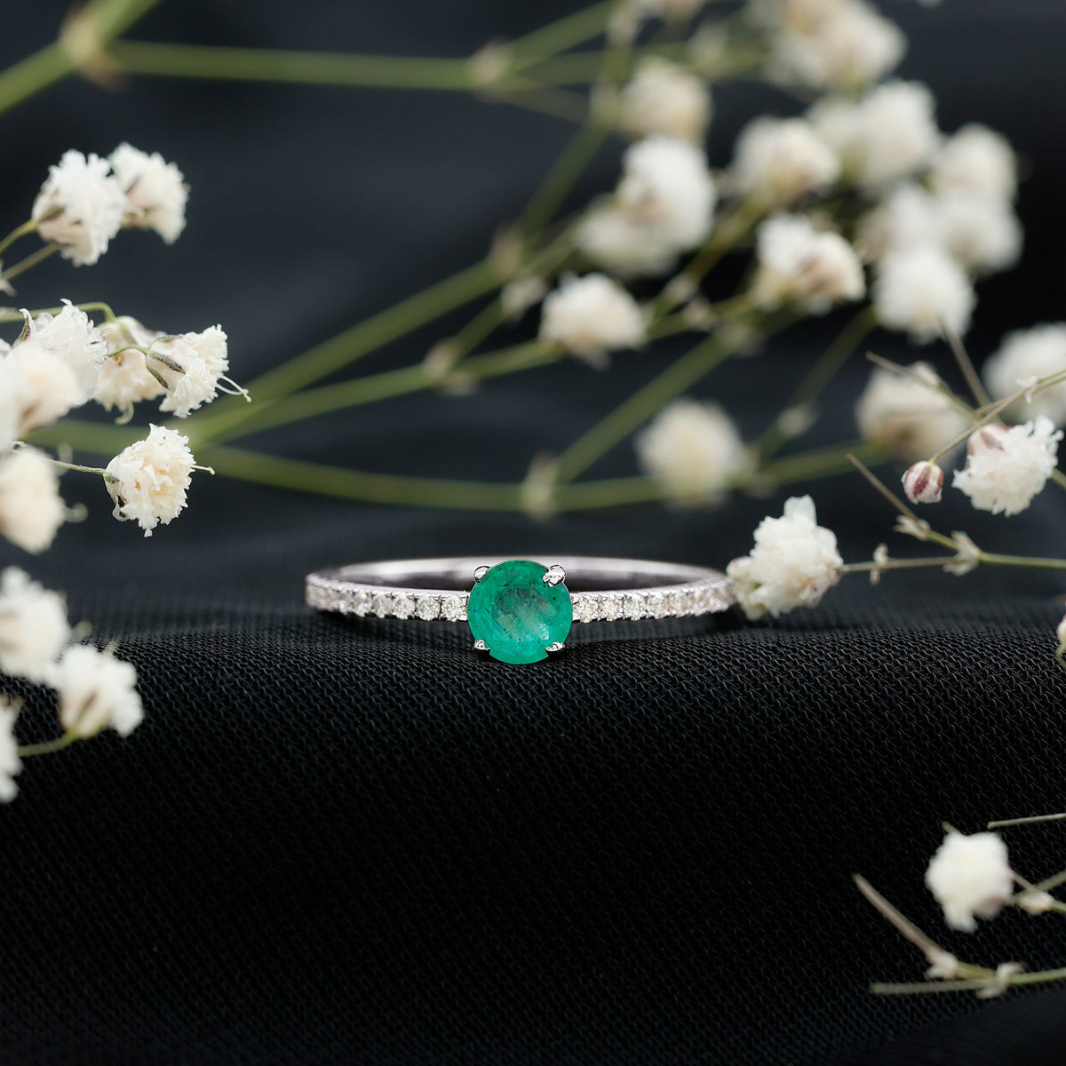 Natural emerald promise ring by Rosec Jewels featuring diamond side stones on a sleek gold band.