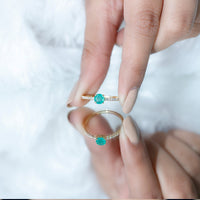 Natural emerald promise ring by Rosec Jewels featuring a central emerald with diamond side stones on a silver band