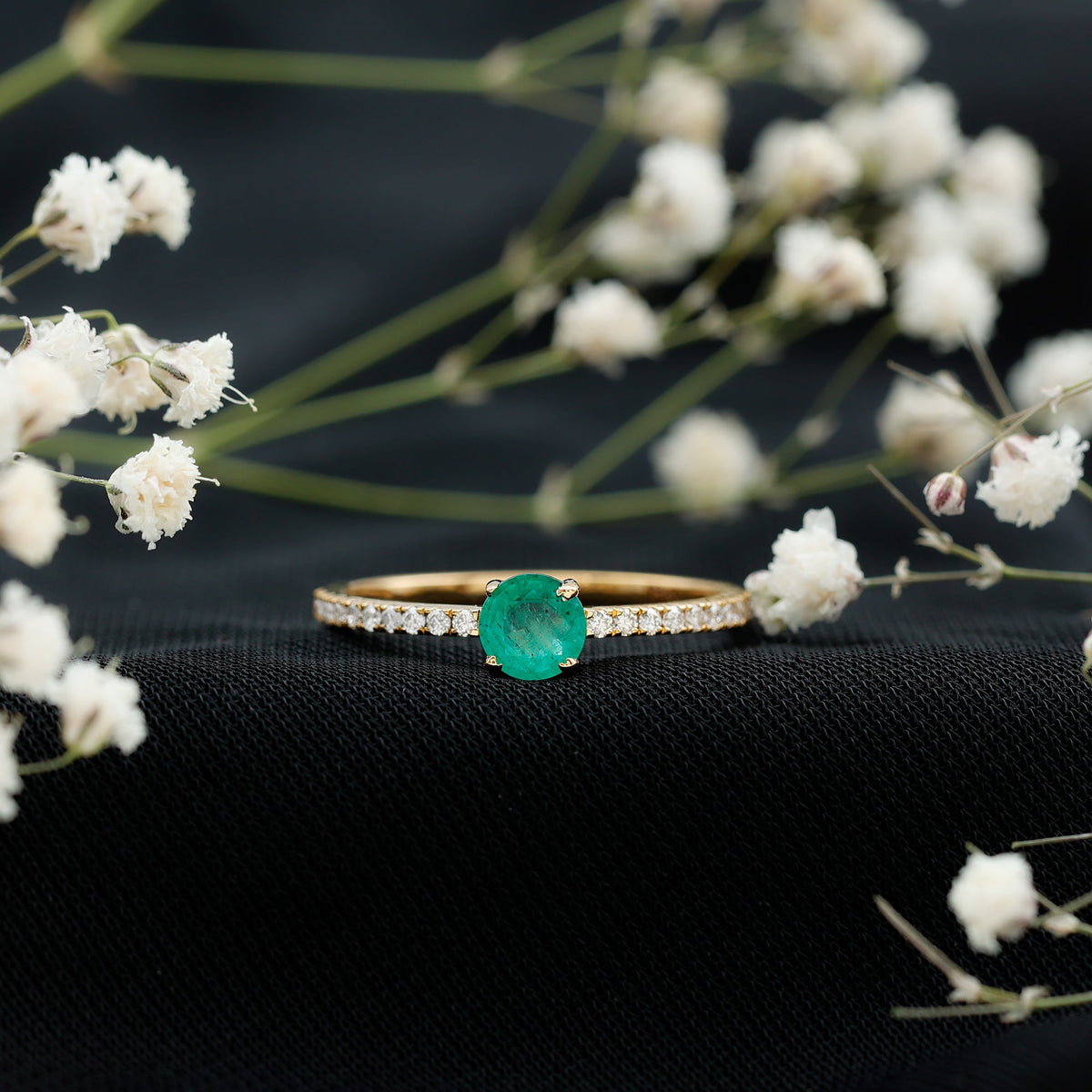 Natural emerald promise ring with diamond side stones by Rosec Jewels, showcasing a green emerald centerpiece and sparkling accents.