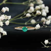 Natural emerald promise ring with diamond side stones by Rosec Jewels, showcasing a green emerald centerpiece and sparkling accents.