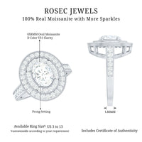 Oval moissanite engagement ring with milgrain embellishments and double halo setting, featuring detailed metalwork and sparkling stones.