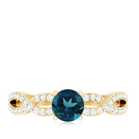 Round Blue Topaz infinity engagement ring with diamonds by Rosec Jewels, featuring a blue topaz centerpiece and sparkling diamond accents.