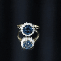 Rosec Jewels 2 Carat round London Blue Topaz engagement ring with diamond halo, featuring a classic design and yellow gold band.