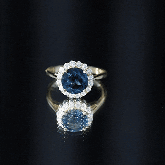 Rosec Jewels 2 Carat round London Blue Topaz engagement ring with diamond halo, featuring a classic design and yellow gold band.