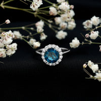 Rosec Jewels 2 Carat round London Blue Topaz engagement ring with diamond halo, showcasing a classic design and sparkling gemstones.