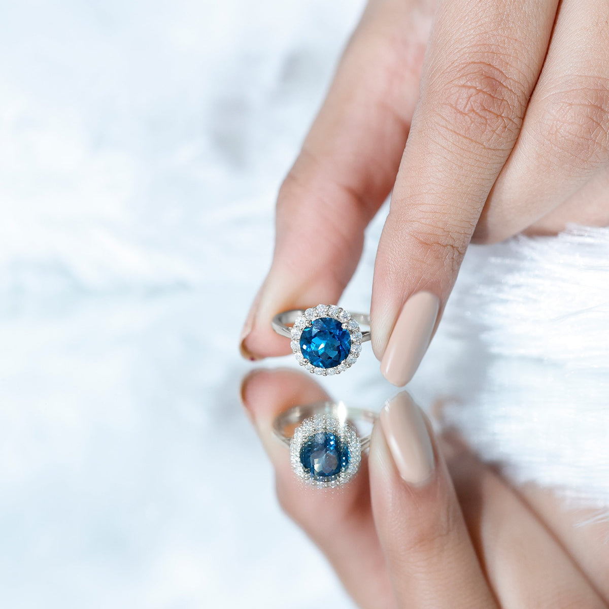 Rosec Jewels 2 Carat London Blue Topaz engagement ring with diamond halo, showcasing a round blue gemstone and elegant platinum band