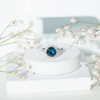Rosec Jewels 2 Carat round London Blue Topaz engagement ring with diamond halo, showcasing a sparkling blue gemstone and elegant design.