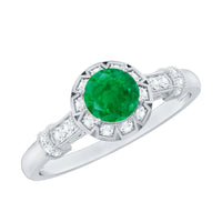 Vintage-inspired emerald engagement ring with diamond accents by Rosec Jewels, showcasing intricate design and sparkling gemstones.