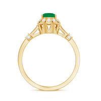 Vintage-inspired emerald engagement ring with diamond accents from Rosec Jewels, showcasing a detailed gold band and sparkling gemstones.