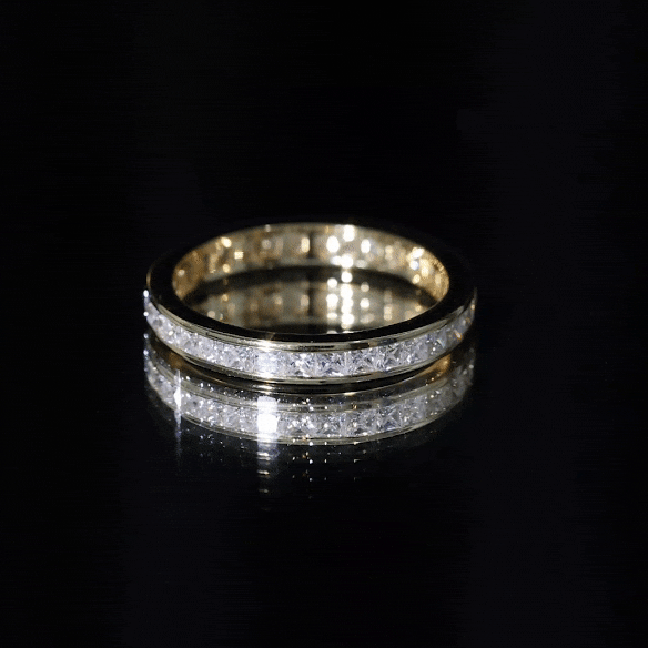 Yellow gold princess cut moissanite eternity band ring in channel setting by Rosec Jewels, showcasing sparkling gemstones around the band.