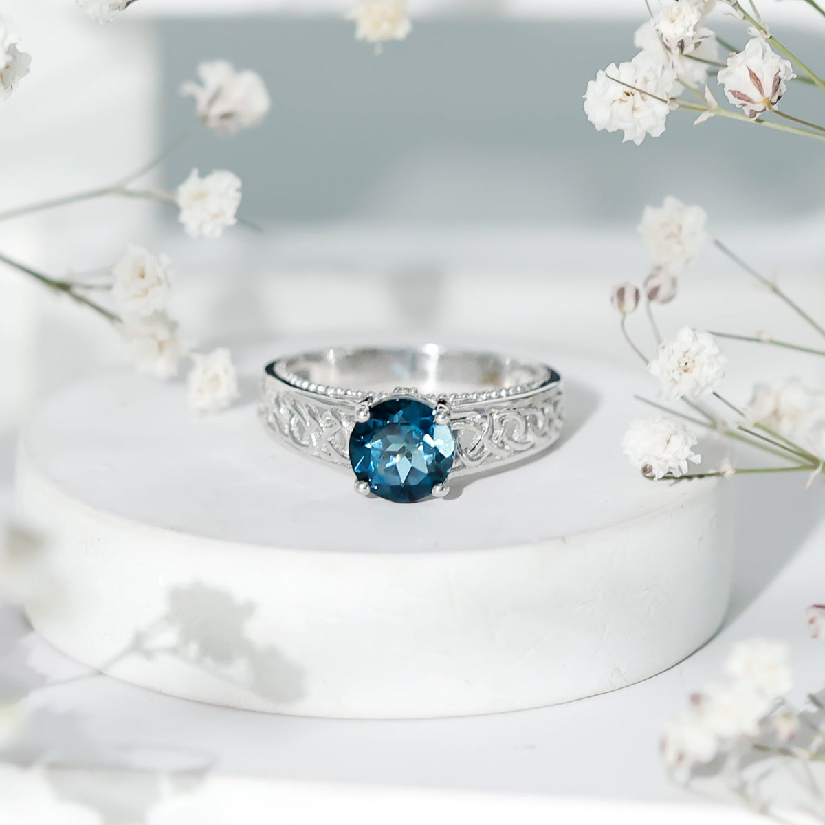 Round 1.35 Carat London Blue Topaz vintage engagement ring with Celtic style band, featuring detailed metalwork and sparkling gemstone.