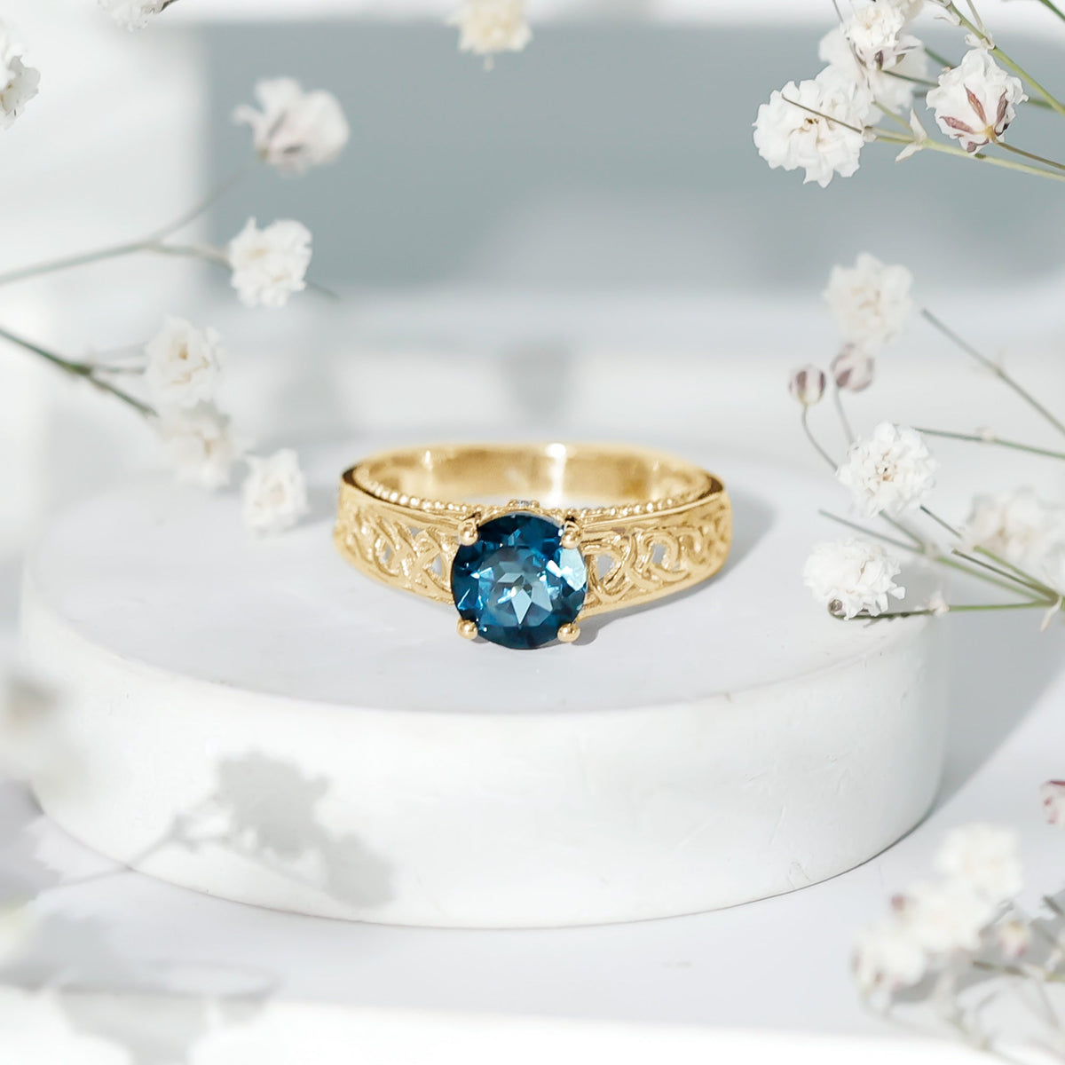 Round 1.35 carat London Blue Topaz vintage engagement ring with Celtic-style band by Rosec Jewels shown in detailed close-up.