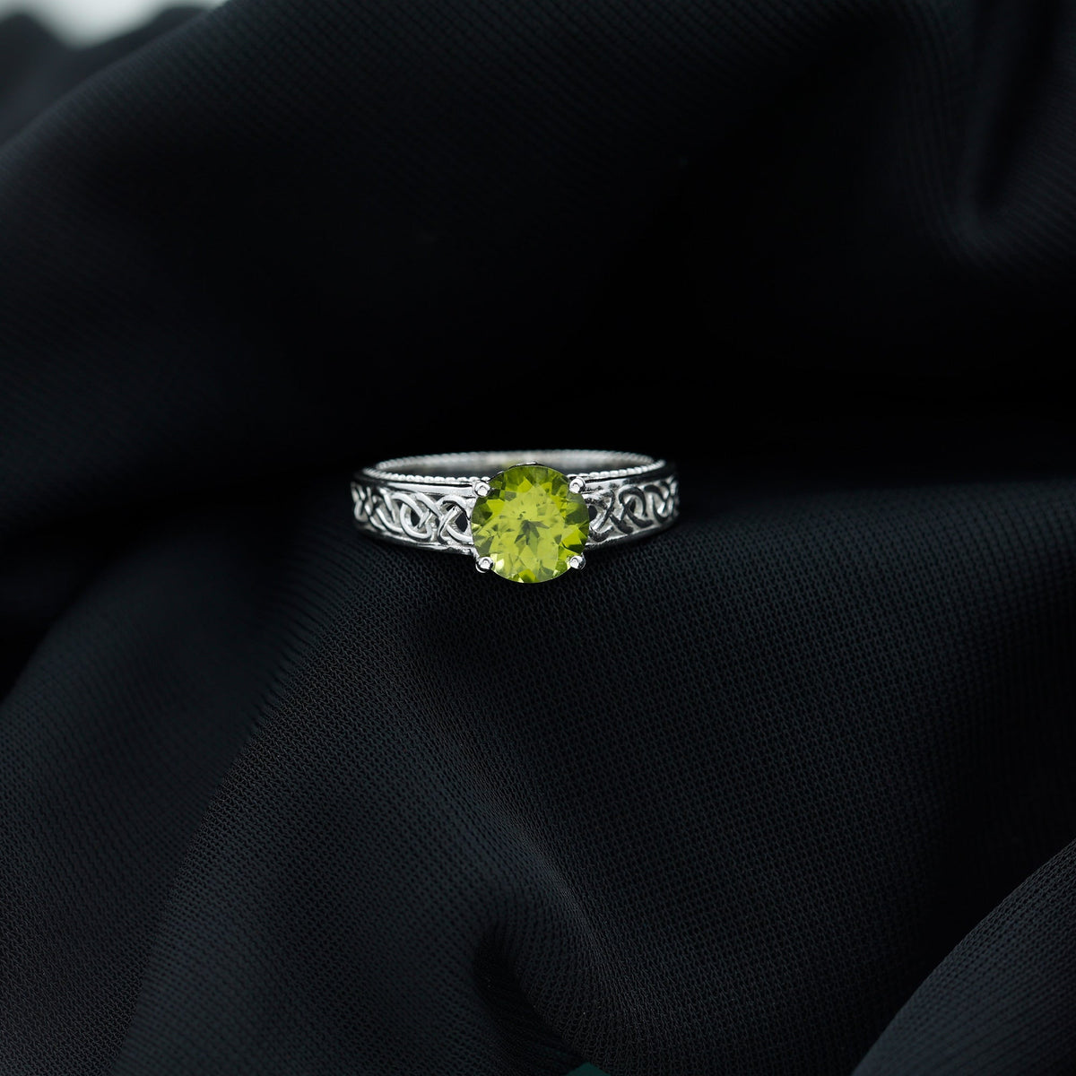 Real 2 Carat Peridot Celtic Knot Engagement Ring with Surprise Diamond, featuring intricate design and sparkling gemstone accents.
