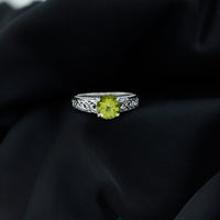 Real 2 Carat Peridot Celtic Knot Engagement Ring with Surprise Diamond, featuring intricate design and sparkling gemstone accents.