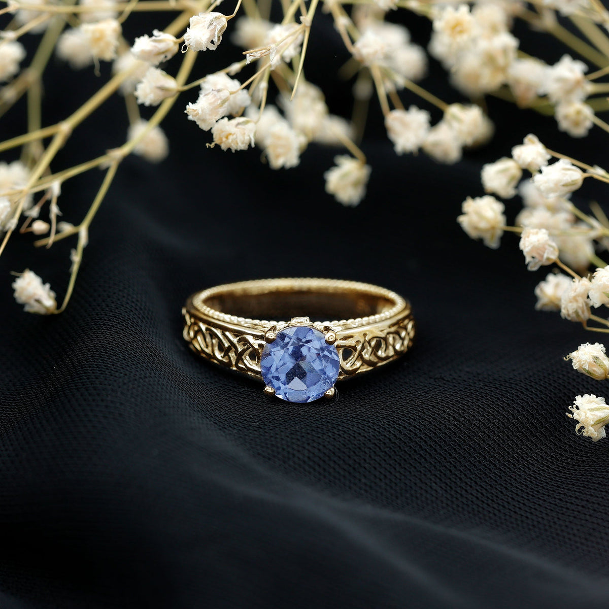 Rosec Jewels 1.6 Carat Lab Created Tanzanite engagement ring with intricate Celtic design and silver band.