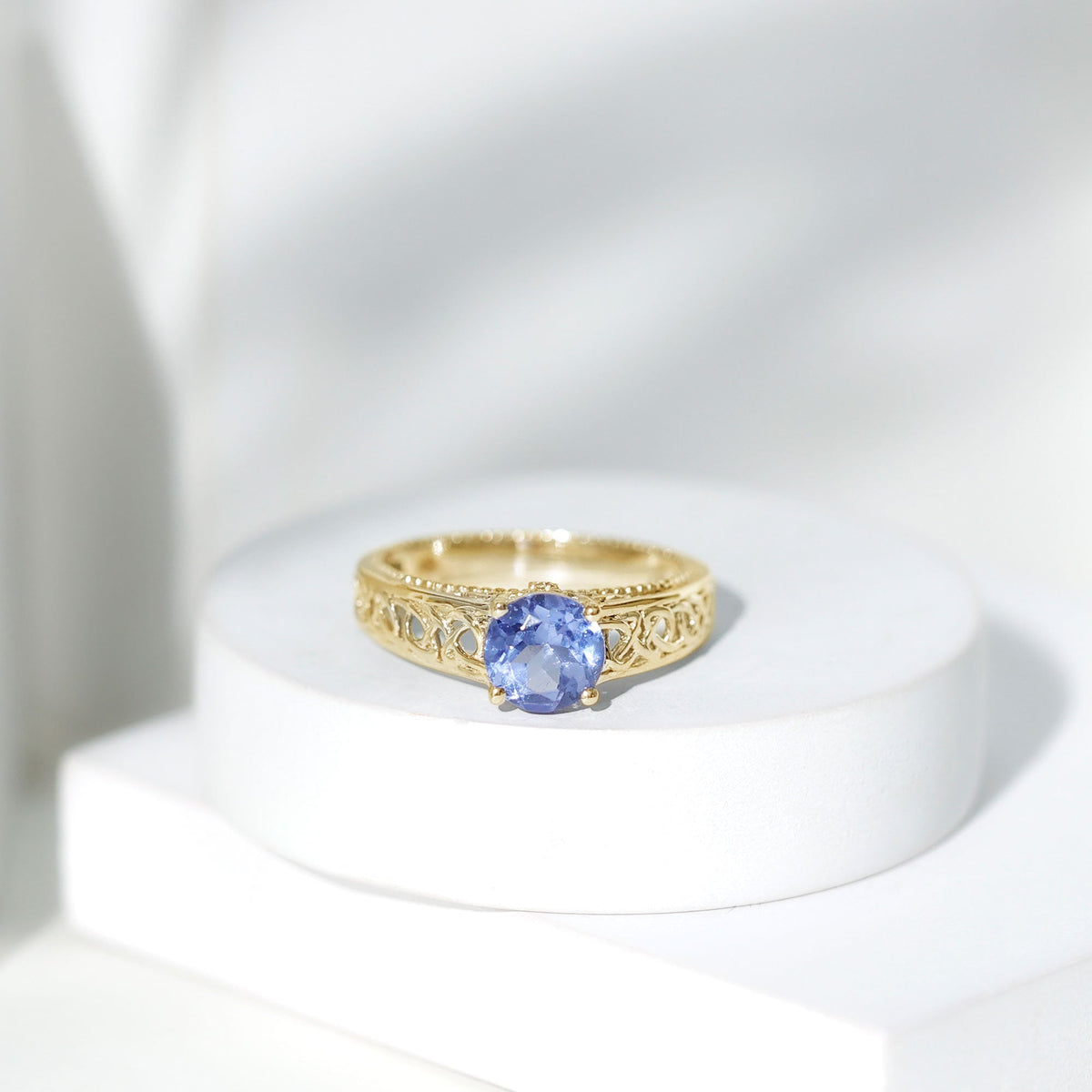 Rosec Jewels 1.6 Carat Lab Created Tanzanite engagement ring with intricate Celtic design and silver band, close-up view