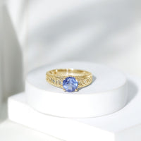 Rosec Jewels 1.6 Carat Lab Created Tanzanite engagement ring with intricate Celtic design and silver band, close-up view