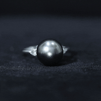 Round Tahitian pearl solitaire engagement ring with Moissanite, featuring a sleek band and elegant design by Rosec Jewels.