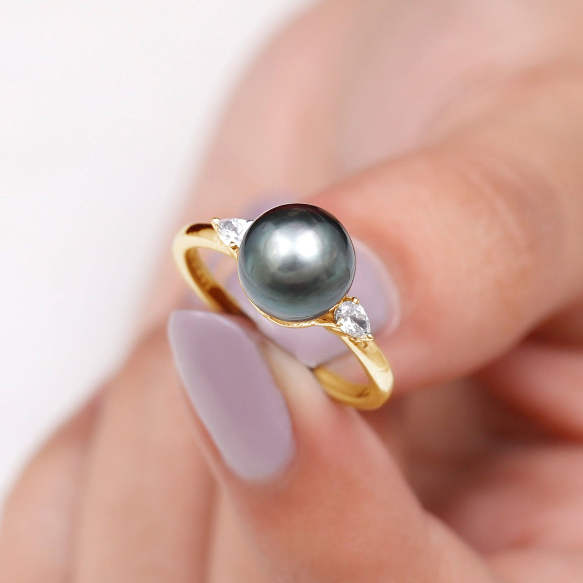 Round Tahitian pearl solitaire engagement ring with moissanite by Rosec Jewels, showcasing the elegant pearl and sparkling gemstone setting.