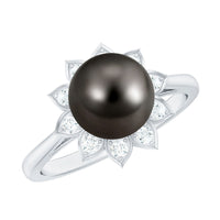 Tahitian black pearl engagement ring with diamond floral halo by Rosec Jewels, featuring a central black pearl surrounded by sparkling diamonds.