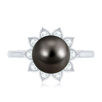 Tahitian black pearl engagement ring with diamond floral halo, showcasing elegant craftsmanship and sparkling accents by Rosec Jewels.
