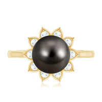 Tahitian black pearl engagement ring with diamond floral halo by Rosec Jewels, showcasing a stunning black pearl center and intricate halo design.