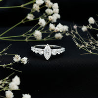 Marquise cut moissanite engagement ring with side stones from Rosec Jewels, showcasing sparkling center stone and elegant band.