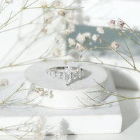 Marquise cut moissanite engagement ring with side stones by Rosec Jewels, showcasing a sparkling central gemstone and detailed band.