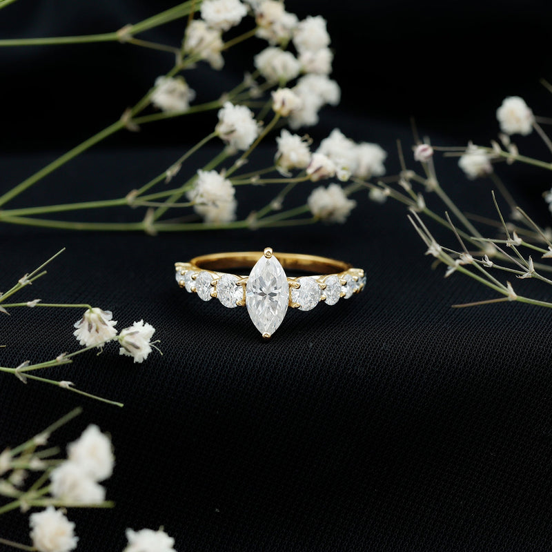 Marquise cut moissanite engagement ring with side stones from Rosec Jewels, showcasing sparkling center stone and elegant band.