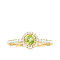 Genuine half carat peridot engagement ring with diamond halo, featuring rose gold band and intricate detailing.