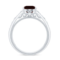 Vintage style garnet and diamond engagement ring with Celtic knot design by Rosec Jewels, showcasing intricate metalwork and gemstone details.