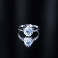 Yellow gold pear-shaped aquamarine engagement ring with diamond halo by Rosec Jewels, showcasing intricate design and sparkling gemstones.