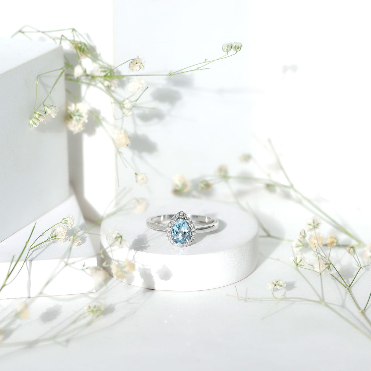 1 Carat pear-shaped aquamarine engagement ring with diamond halo by Rosec Jewels, showcasing the elegant gemstone and sparkling setting.