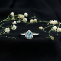 Pear-shaped 1 carat aquamarine engagement ring with diamond halo by Rosec Jewels, featuring a sterling silver band.