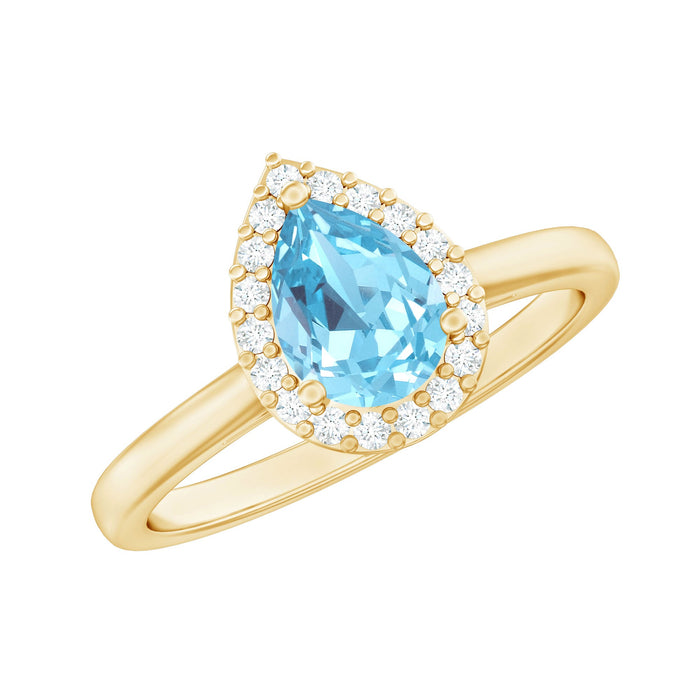Pear cut aquamarine engagement ring with diamond halo from Rosec Jewels, showcasing the elegant blue gemstone and sparkling halo setting.