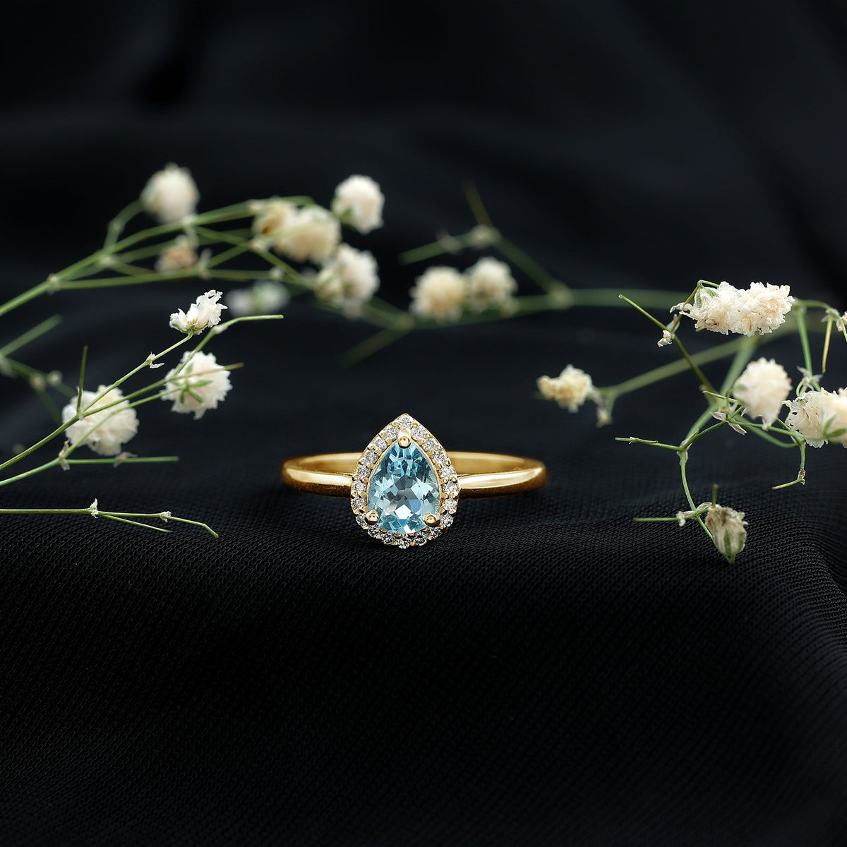 Pear cut aquamarine engagement ring with diamond halo featuring a 1-carat gemstone, set in a rose gold band by Rosec Jewels