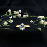 Pear cut aquamarine engagement ring with diamond halo featuring a 1-carat gemstone, set in a rose gold band by Rosec Jewels