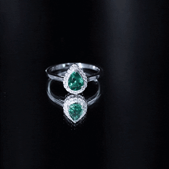 Real emerald teardrop engagement ring with diamond halo featuring a white gold band from Rosec Jewels.