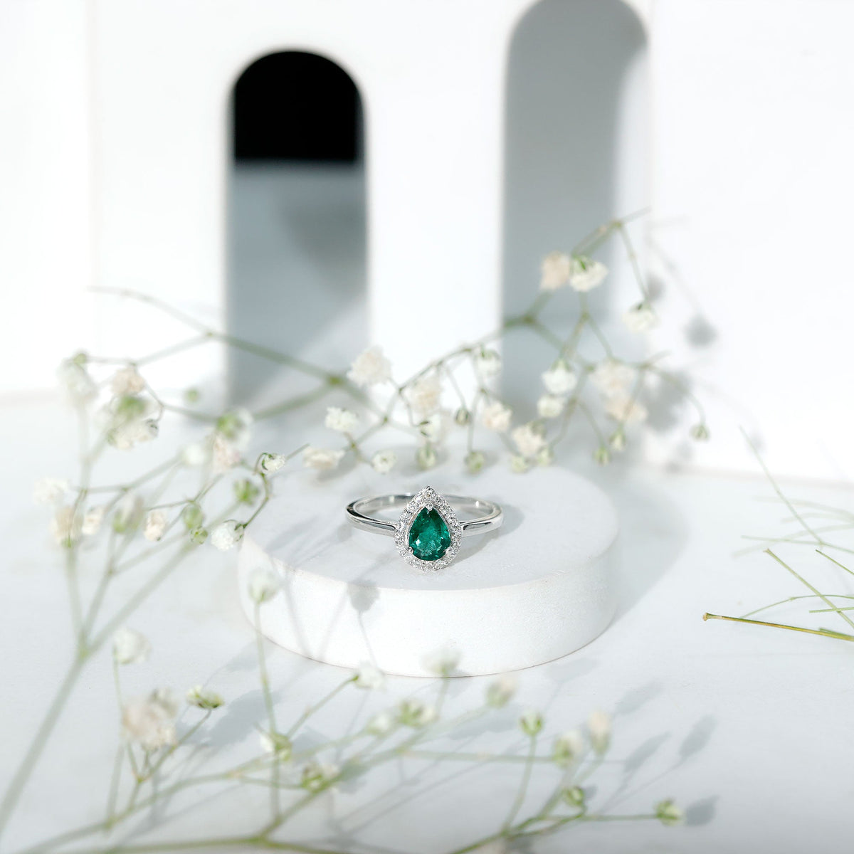Real emerald teardrop engagement ring with diamond halo and rose gold band from Rosec Jewels, showcasing the intricate design and sparkling stones.