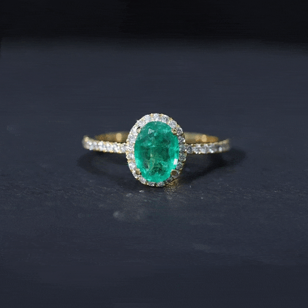 Genuine oval emerald engagement ring with diamond halo, 6x8mm size, featuring yellow gold band and intricate setting.