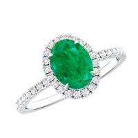 Genuine 6x8mm oval emerald engagement ring with diamond halo from Rosec Jewels, showcasing a detailed silver band and sparkling stones.