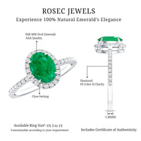Genuine 6x8mm oval emerald engagement ring with diamond halo by Rosec Jewels, showcasing a detailed silver band and sparkling stones.