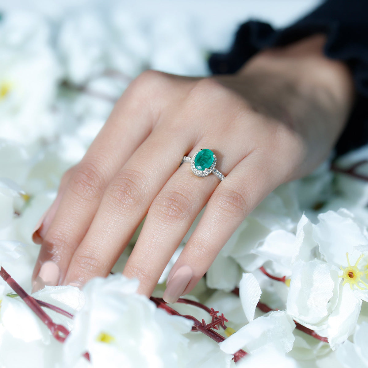 Genuine 6x8mm oval emerald engagement ring with diamond halo and rose gold band by Rosec Jewels.