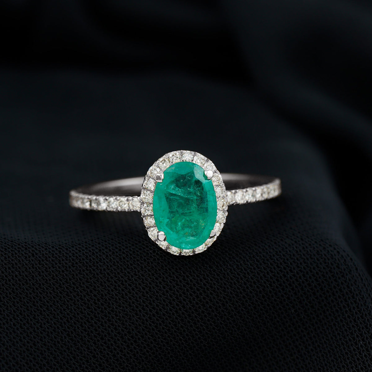 Oval emerald engagement ring with diamond halo in 6x8mm size from Rosec Jewels, showcasing a sparkling gemstone and intricate design.