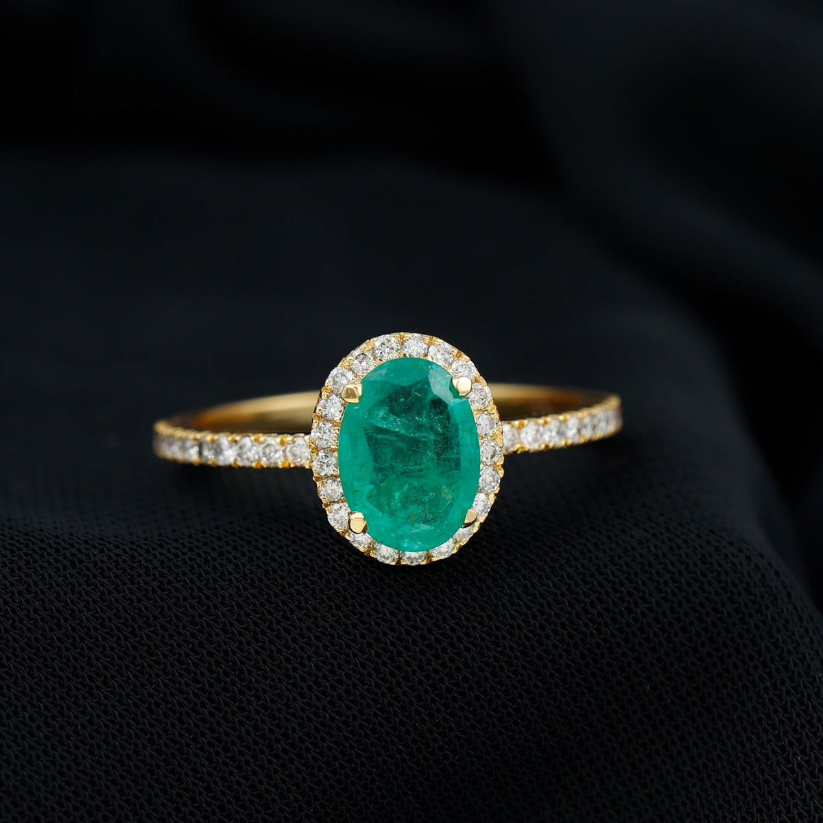 Genuine 6x8mm oval emerald engagement ring with diamond halo by Rosec Jewels, showcasing the detailed ring design and sparkling stones.