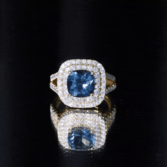 Rosec Jewels 8mm cushion cut London Blue Topaz engagement ring with double halo of moissanite stones, showcasing a yellow gemstone setting.