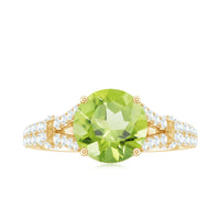 Peridot solitaire engagement ring with moissanite accents and split shank, featuring a rose gold band from Rosec Jewels.